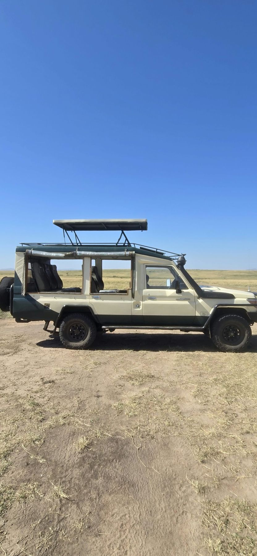 Sylvester's Land Cruiser parked on the open plains