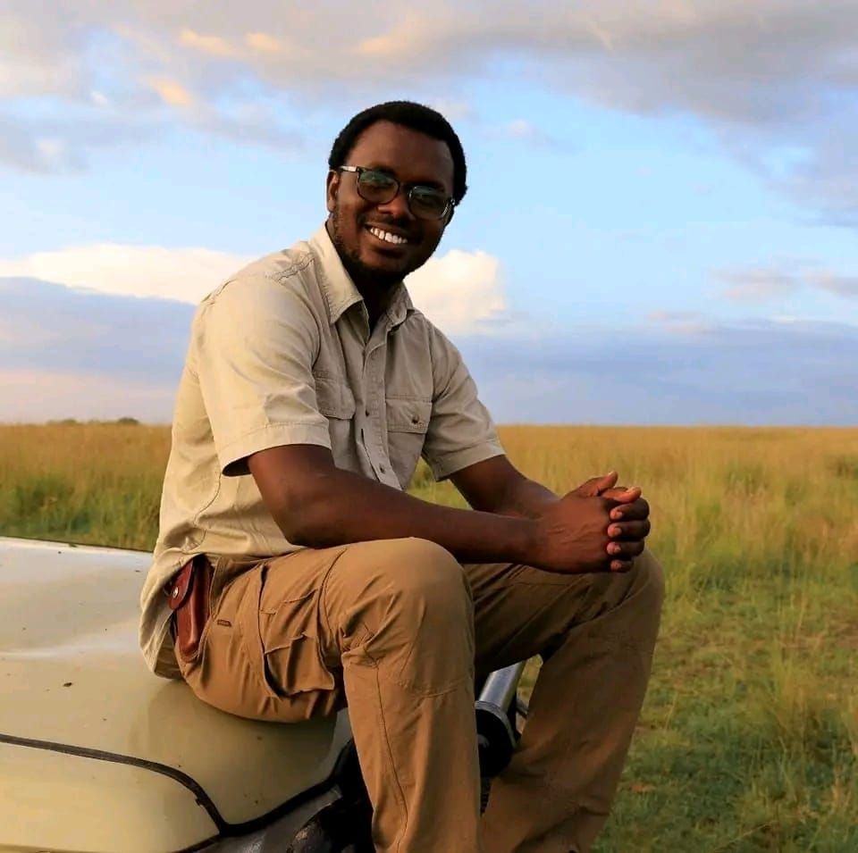 Sylvester sitting on the bonnet of his Land Cruiser