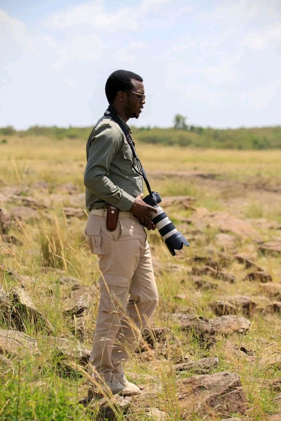 Sylvester holding his camera on the rocky plains