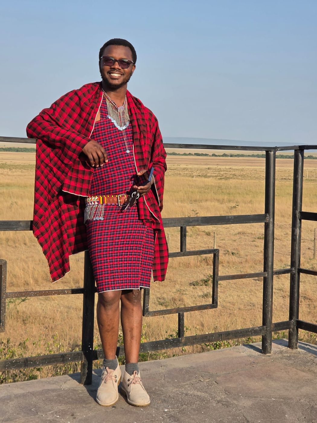 Sylvester in a red shuka at a viewpoint above the Mara